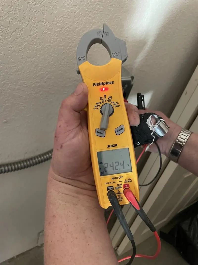 Voltage testing with clamp meter during Recessed Lighting Installation in Chantilly
